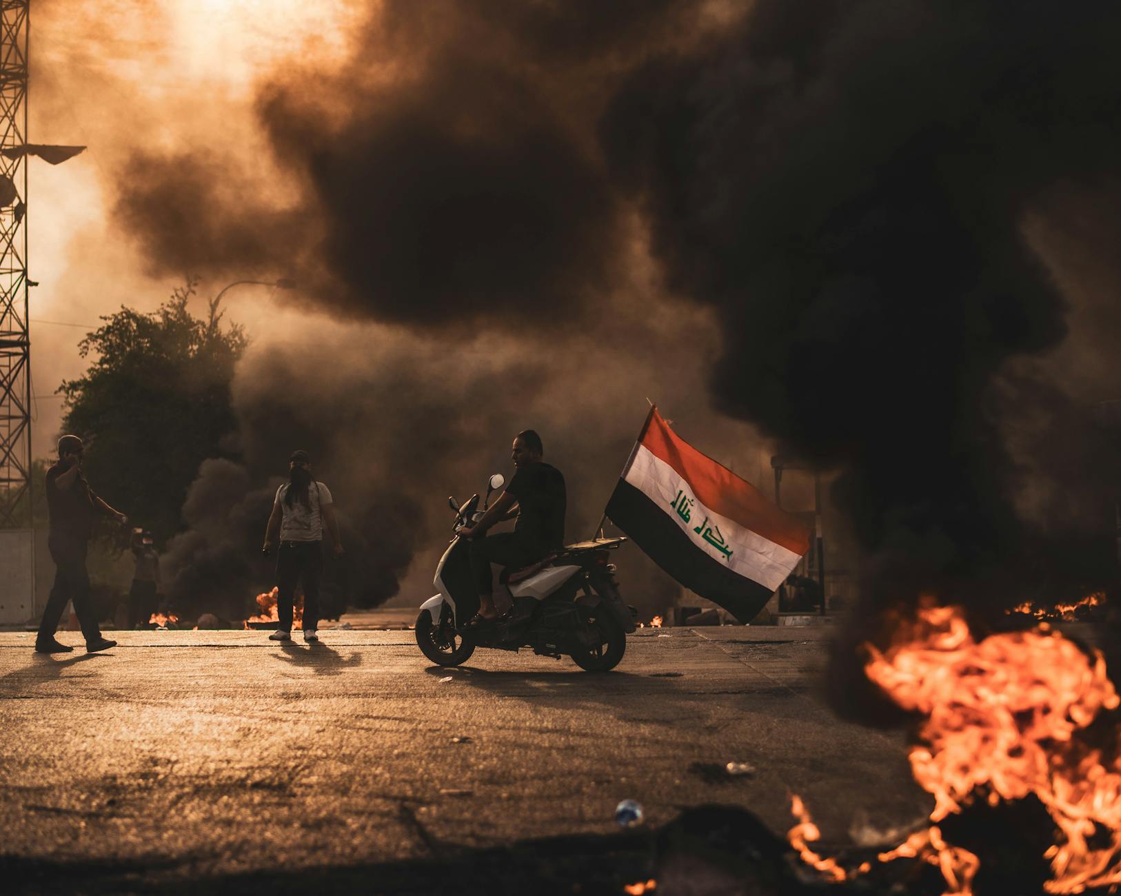 fire and thick black smoke on the road