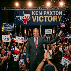 Male politician on stage at a Texas victory rally, crowd waving flags and signs like 'Texas Votes' and 'We Won!' behind him under a large 'Victory' banner with 'KEN PAXTON' text (avoid naming the person).