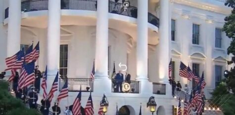 President giving a speech at a podium on the White House Portico, surrounded by American flags.