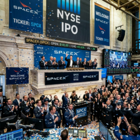 SpaceX executives and traders celebrating IPO launch at NYSE with confetti and banners