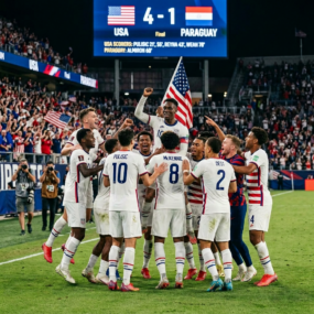 US men's soccer team celebrating 4-1 win against Paraguay with American flag