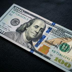 One hundred dollar bill showing Benjamin Franklin portrait and security features
